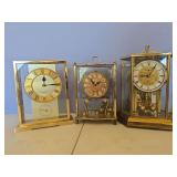 3 brass clocks
