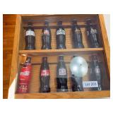Coca Cola bottles in display case