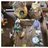 Decorative Frog-Themed Figurines and Birds on Log