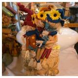 Decorative Scarecrow Figures on Straw Bale
