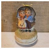 Hummel-Style Figurine of Children Under Umbrella