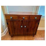 Wooden Cabinet With Blue Knob Accents