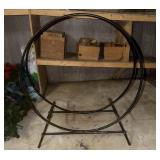 This is a tubular steel log hoop firewood storage