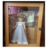 Porcelain Doll in Display Cabinet