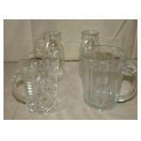 two small pitchers and two small milk bottles