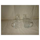 two small pitchers and two small milk bottles