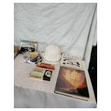 Safety Hats, Rifle Ammo, and Gun Book.