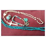 A plastic crucifix, turqouis necklace, bracelet