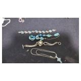 Three bracelets, a cross turqouise necklace