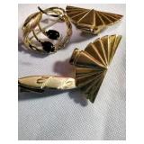 A pair of clip on earrings, pin and tie clasp
