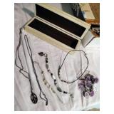 Four bracelets and a necklace.