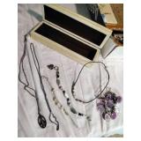 Four bracelets and a necklace.