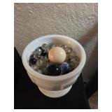 Milk glass full of marbles