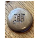 Handcrafted wooden disk featuring a monogrammed