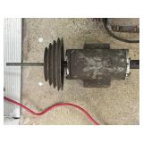 Electric motor with a step pulley attached to its