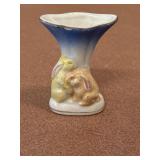 VTG miniature porcelain vase features a hand