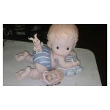 Ceramic Baby Figurine Lying on a Blue and White