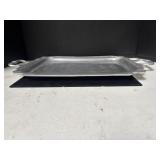 A rectangular metal serving tray with decorative