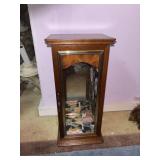 A vintage tabletop wooden jewelry armoire cabinet