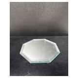 A small, octagonal glass display mirror with