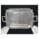A rectangular metal serving tray with decorative