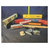Toy train cars, each may have parts missing