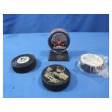 4 NHL Penguins Hockey Pucks,1 on stand,1 signed
