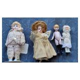4 tiny bisque dolls