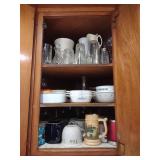 Contents of kitchen cupboard, corningware, cups,