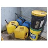 Diesel cans and oil buckets some have contents