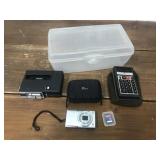 Canon camera, case, SD card, calculator, cassette