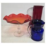 Colored glass pitchers and bowl