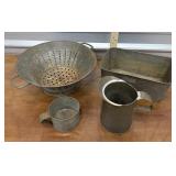 Tin kitchen strainer, pitcher, cup, and pan