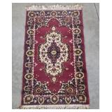 Small Oriental throw rug - aprx 25x45