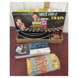 Melody train, AFT tool tin chest, and marble pin