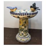 Tile looking bird bath with 2 birds -