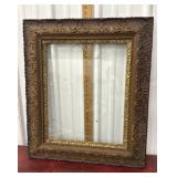 Ornate gold, gildedframe with glass