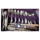 Set of silverware in case with odd pieces