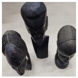 Three hand carved head statues