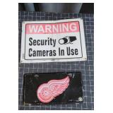 This two-piece metal sign lot features a Red Wings