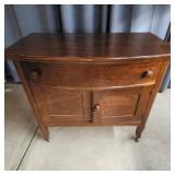 Antique oak washstand featuring a serpentine front