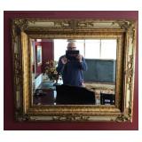 Beveled glass mirror in ornate frame