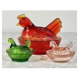 3 colored pressed glass hens on nest