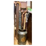 Milk can with walking sticks, umbrella,