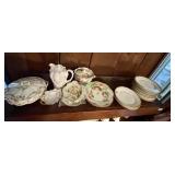 All porcelain and china on top of cabinet