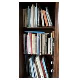 3 shelves of books in window seat cubby
