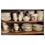 Shelf with bone china dinner plates, cups,
