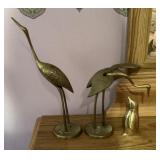 Brass cranes and penguin