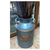 Milk can with feathers