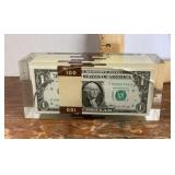 $1 bills in lucite paperweight